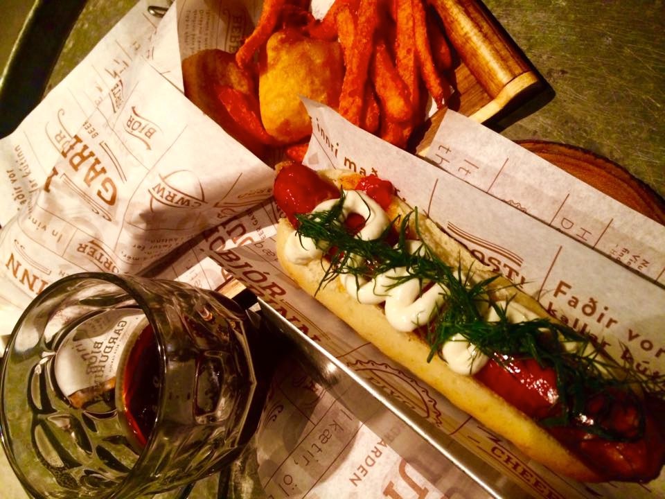 Thanksgiving dinner: gourmet dog with fresh peppers and dill, fish and chips, Icelandic beer